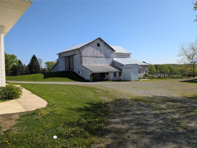 15916 Airport Rd, Linesville, PA 16424 - view of front of property with a barn, an outdoor structure, a front lawn, and metal roof