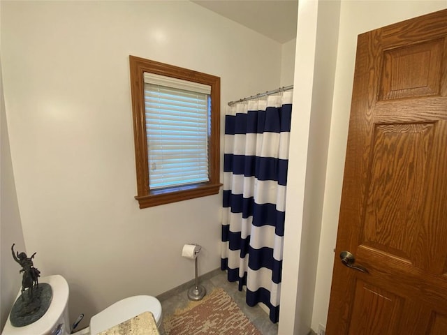 bathroom with a shower with shower curtain and tile patterned floors