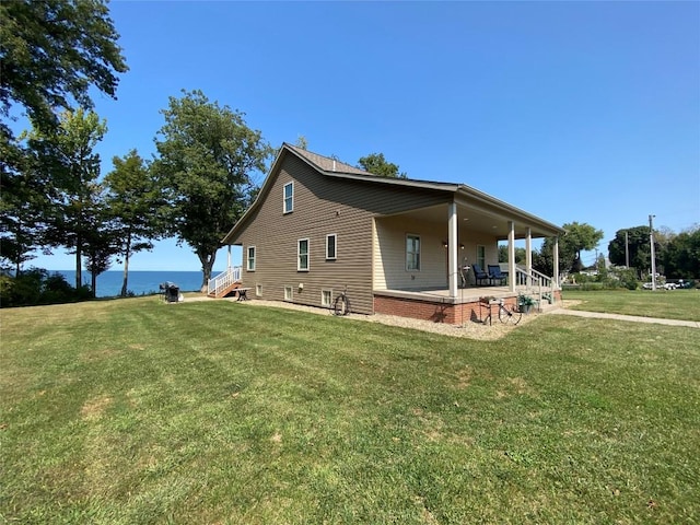 view of property exterior featuring a water view and a lawn