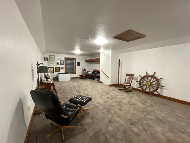 sitting room featuring carpet floors and vaulted ceiling