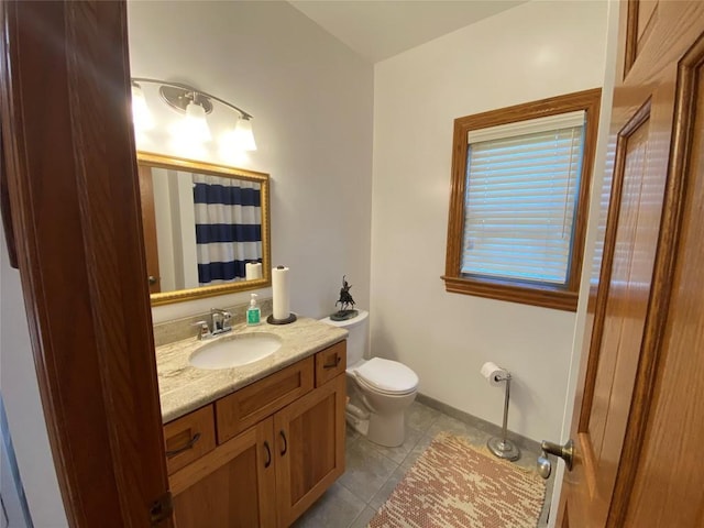 bathroom featuring tile patterned floors, vanity, and toilet