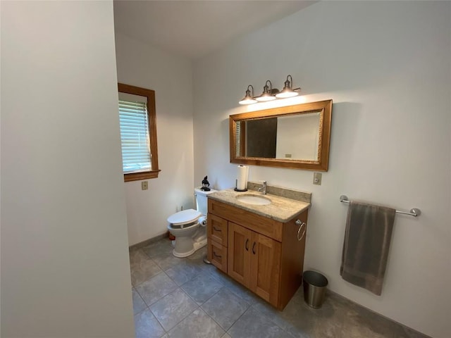 bathroom featuring tile patterned floors, vanity, and toilet