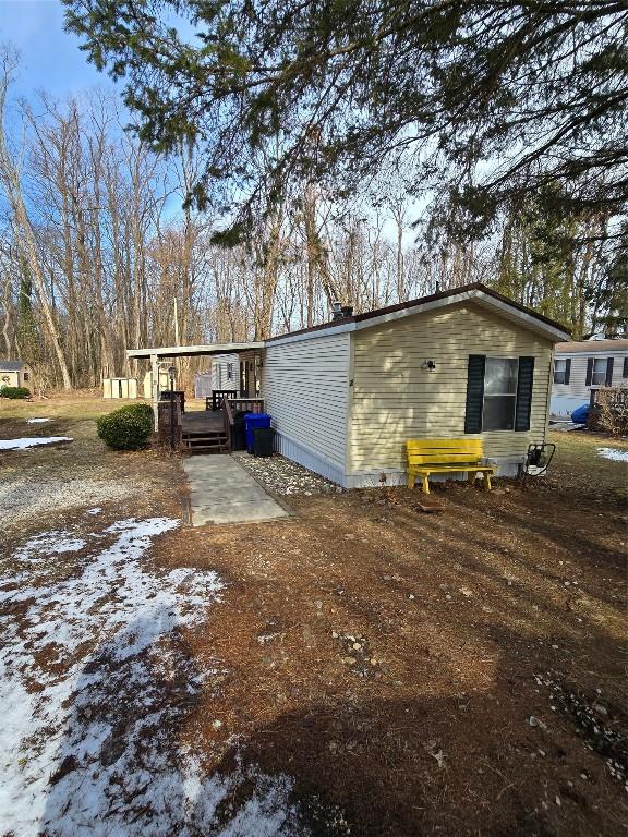 back of property with a patio and a wooden deck