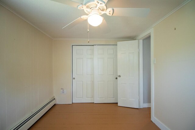 5499 Pinetree Rd, Mckean, PA 16426 - unfurnished bedroom featuring a baseboard radiator, wood finished floors, a closet, crown molding, and ceiling fan