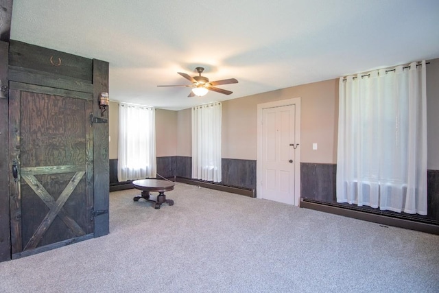 5499 Pinetree Rd, Mckean, PA 16426 - carpeted spare room with wainscoting, ceiling fan, and a baseboard heating unit