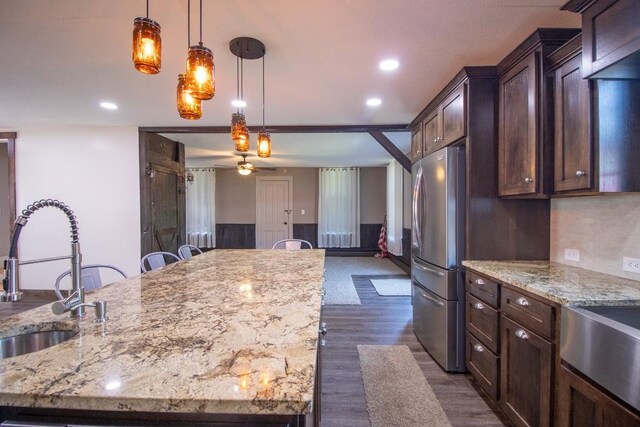 5499 Pinetree Rd, Mckean, PA 16426 - kitchen featuring freestanding refrigerator, dark wood-type flooring, light stone counters, hanging light fixtures, and recessed lighting
