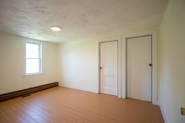 5499 Pinetree Rd, Mckean, PA 16426 - unfurnished bedroom featuring light wood finished floors, a textured ceiling, and baseboard heating