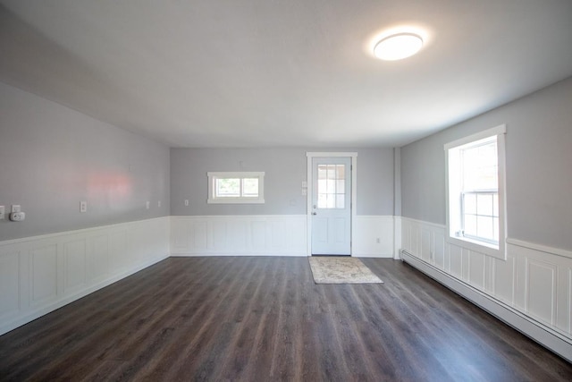 5499 Pinetree Rd, Mckean, PA 16426 - unfurnished room with baseboard heating, a wainscoted wall, and dark wood-style flooring