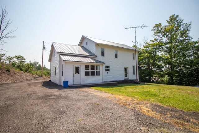 5499 Pinetree Rd, Mckean, PA 16426 - rear view of property with a metal roof, driveway, and a yard