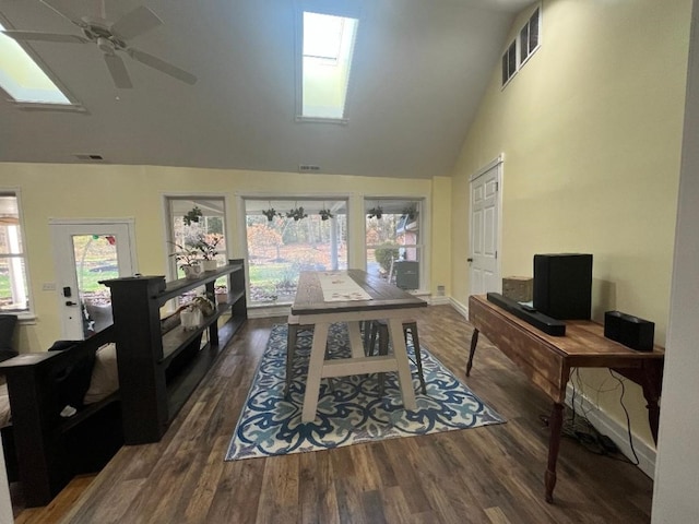 office area with a skylight, high vaulted ceiling, dark hardwood / wood-style floors, and ceiling fan