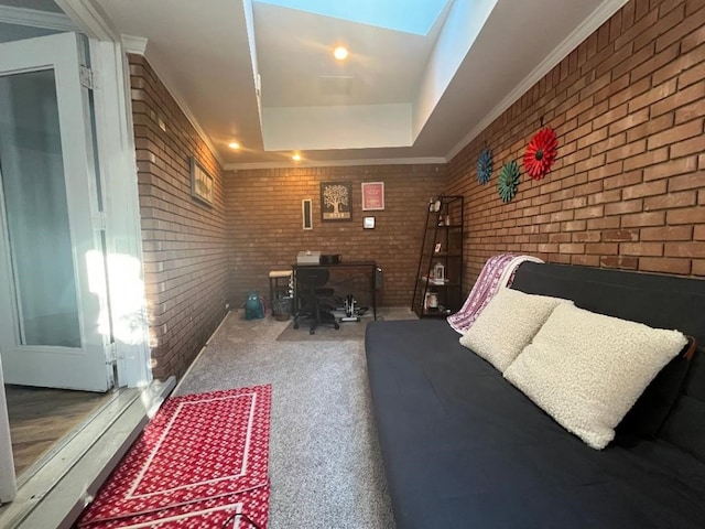 office space featuring a raised ceiling, ornamental molding, and brick wall