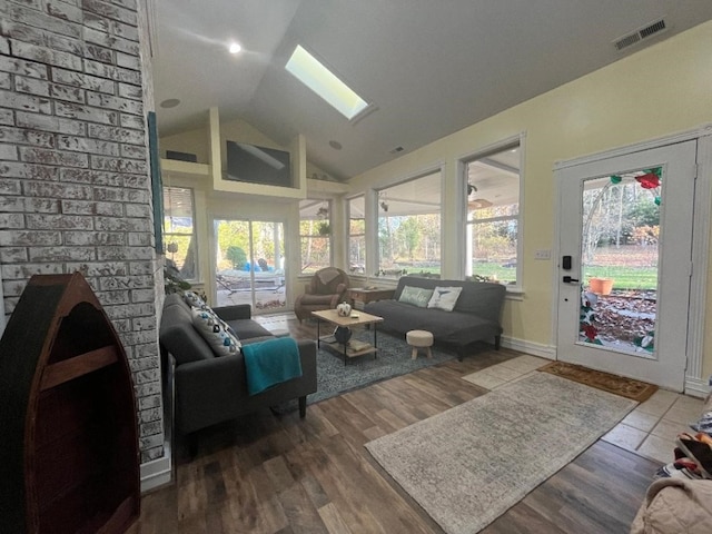 sunroom / solarium with vaulted ceiling with skylight