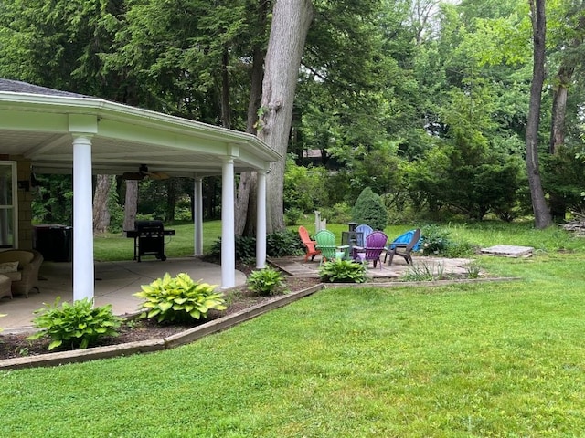 view of yard featuring a patio and ceiling fan