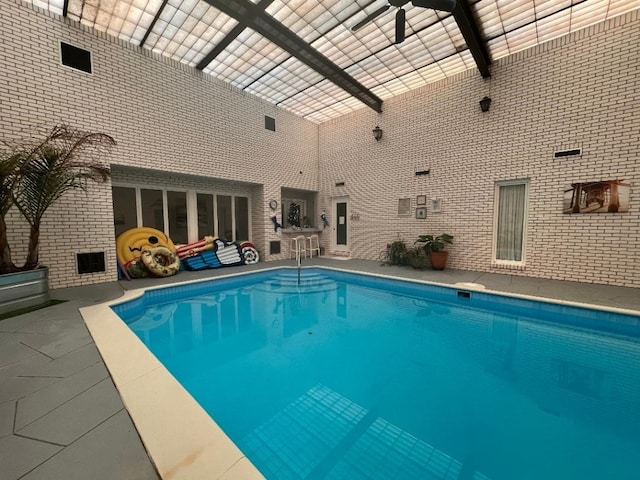 view of swimming pool with a patio area and ceiling fan