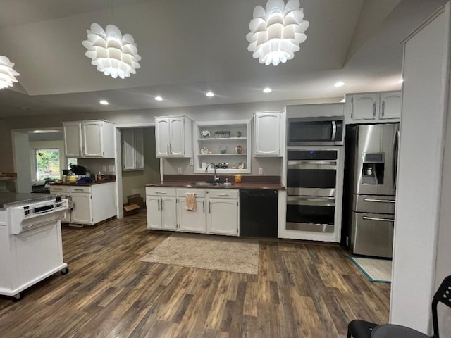 kitchen with white cabinets, sink, appliances with stainless steel finishes, and an inviting chandelier