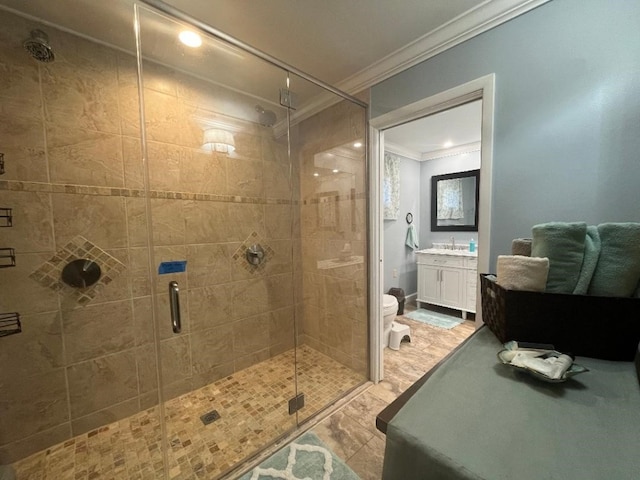 bathroom featuring crown molding, a shower with door, vanity, and toilet