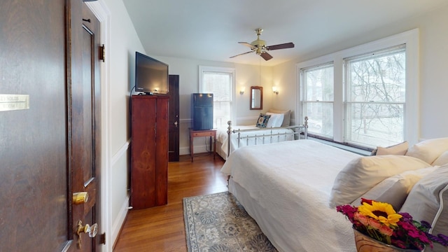 bedroom featuring multiple windows, ceiling fan, and light hardwood / wood-style floors