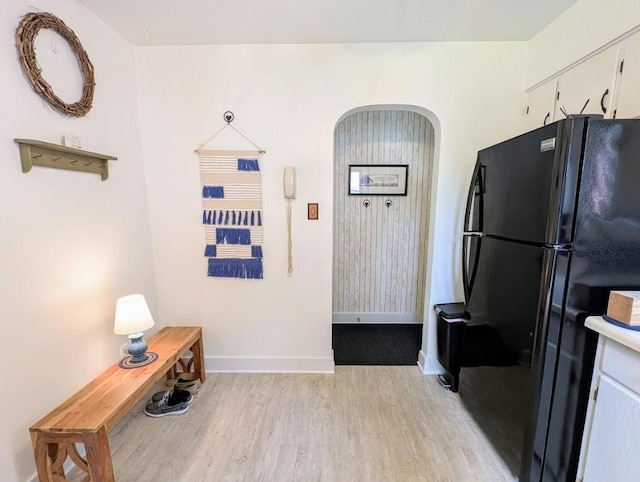 933 E 31st St, Erie, PA 16504 - kitchen with freestanding refrigerator, light wood-style flooring, arched walkways, white cabinetry, and light countertops