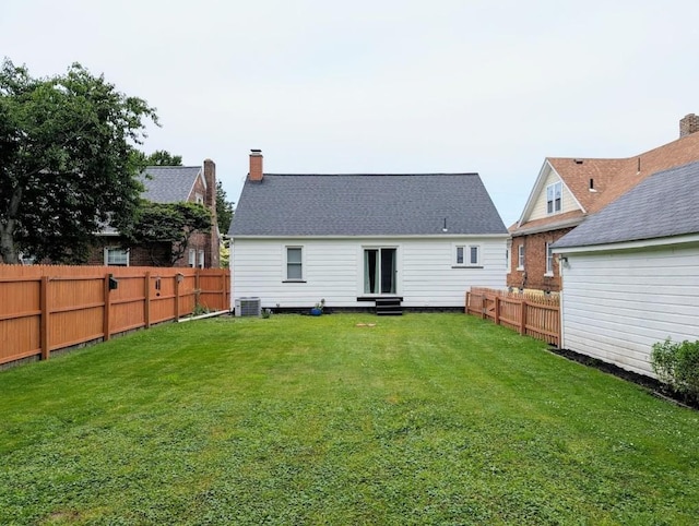 933 E 31st St, Erie, PA 16504 - rear view of property featuring entry steps, a fenced backyard, and a chimney