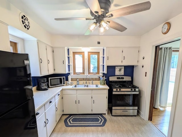 933 E 31st St, Erie, PA 16504 - kitchen with appliances with stainless steel finishes, plenty of natural light, light wood-style flooring, and white cabinetry