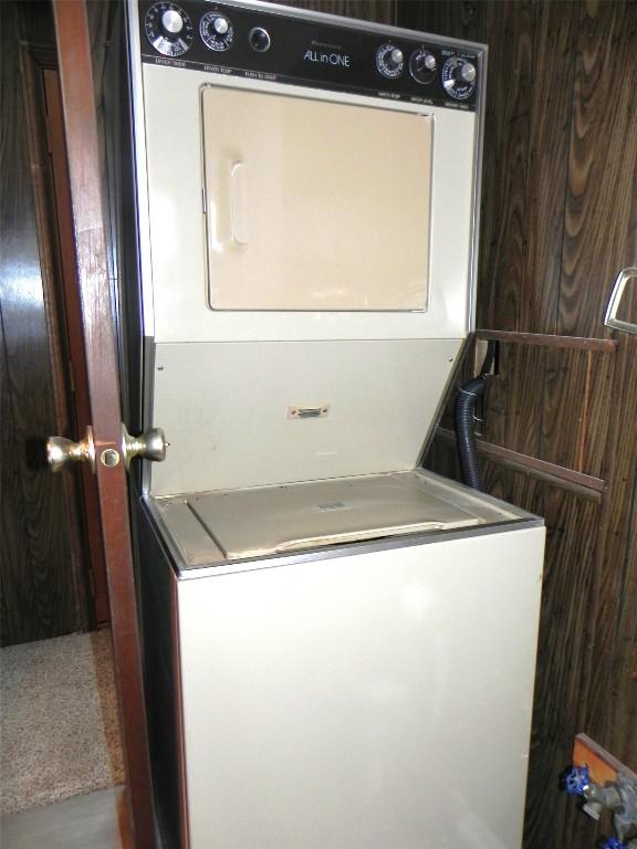 laundry area featuring laundry area and stacked washer and clothes dryer