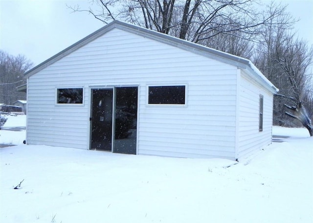 view of snow covered rear of property