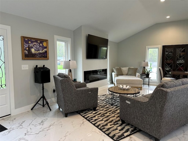 living room with marble finish floor, recessed lighting, vaulted ceiling, baseboards, and a glass covered fireplace