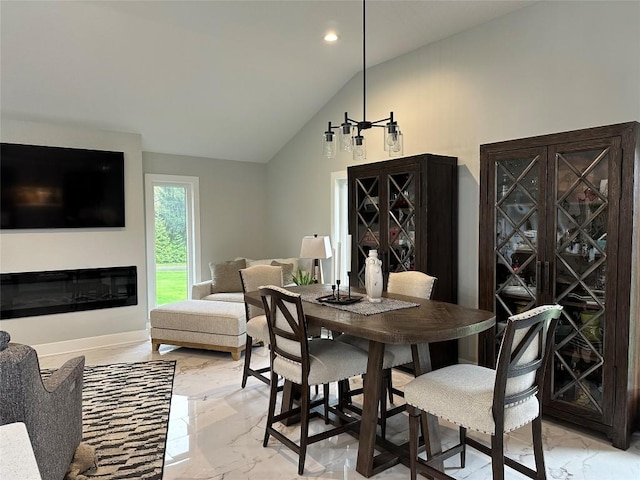 6170 Mistletoe Ave, Fairview, PA 16415 - dining space featuring light marble finish floors, lofted ceiling, recessed lighting, a glass covered fireplace, and baseboards