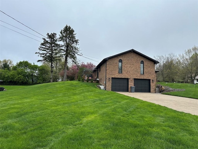 6170 Mistletoe Ave, Fairview, PA 16415 - view of property exterior with an attached garage, a yard, brick siding, and concrete driveway