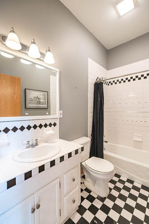 4031 Zimmerly Rd, Erie, PA 16506 - bathroom featuring tile patterned floors, vanity, tasteful backsplash, and shower / bath combination with curtain