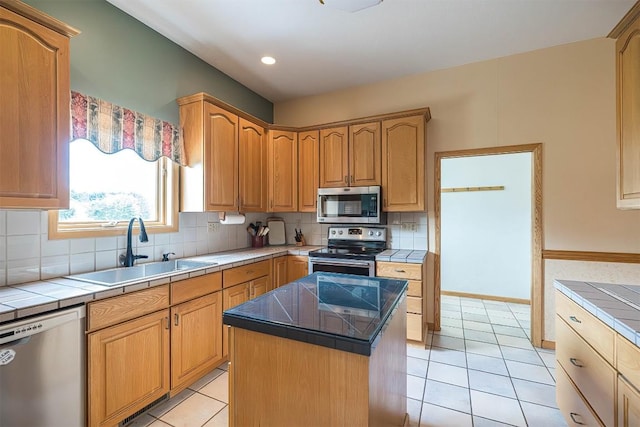 4031 Zimmerly Rd, Erie, PA 16506 - kitchen featuring appliances with stainless steel finishes, tile countertops, light tile patterned floors, decorative backsplash, and recessed lighting