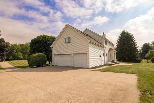 4031 Zimmerly Rd, Erie, PA 16506 - view of side of home with a garage, a lawn, driveway, and a chimney