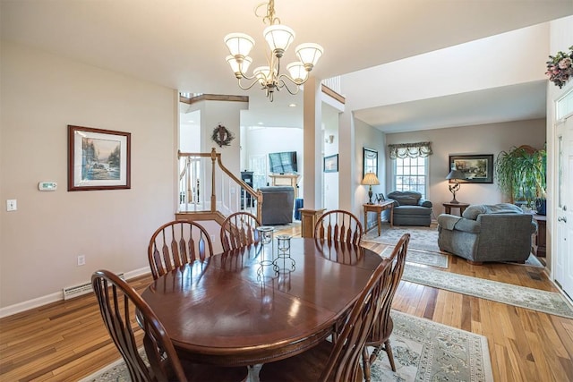 6018 Pebble Creek Dr, Fairview, PA 16415 - dining room featuring a chandelier, light wood-style floors, stairs, and baseboards