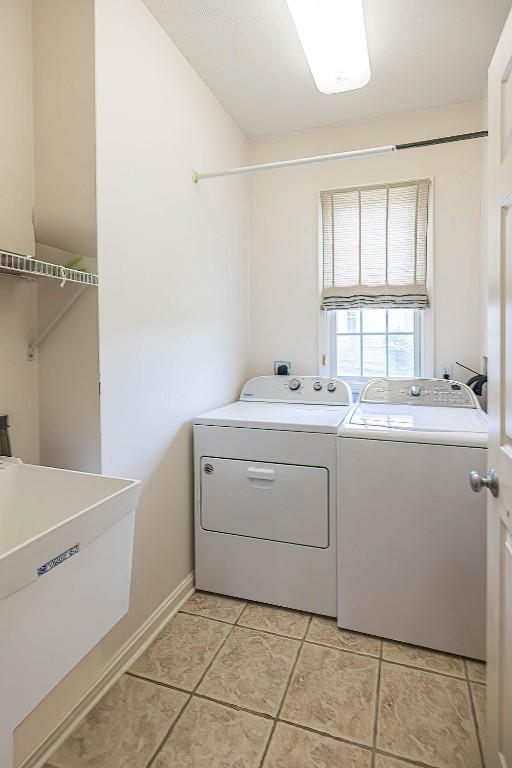 6018 Pebble Creek Dr, Fairview, PA 16415 - laundry area featuring washing machine and dryer and light tile patterned floors