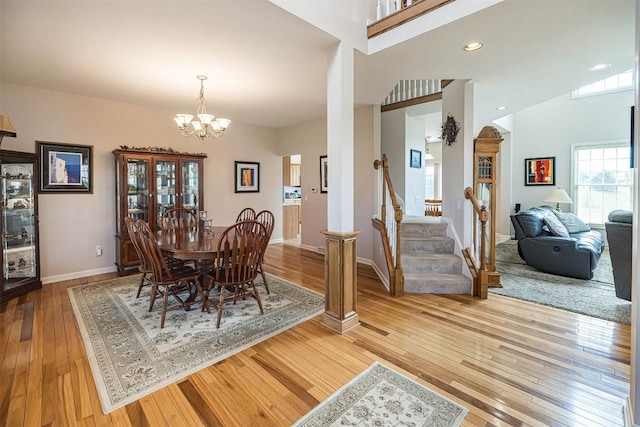 6018 Pebble Creek Dr, Fairview, PA 16415 - dining room featuring light wood-style flooring, a chandelier, stairs, and baseboards