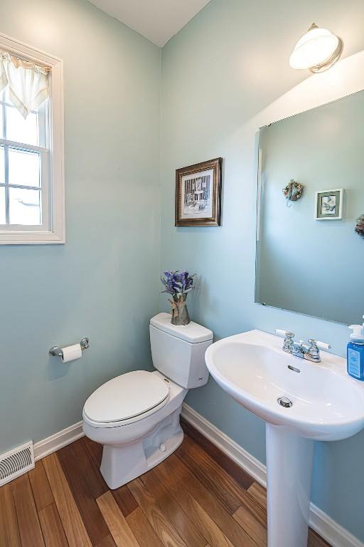 6018 Pebble Creek Dr, Fairview, PA 16415 - half bathroom with wood finished floors, toilet, and baseboards