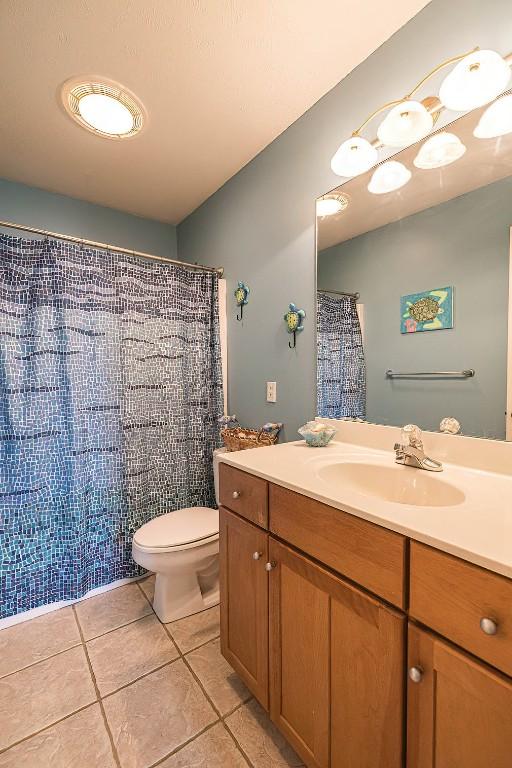 6018 Pebble Creek Dr, Fairview, PA 16415 - full bath featuring tile patterned flooring, toilet, vanity, and curtained shower
