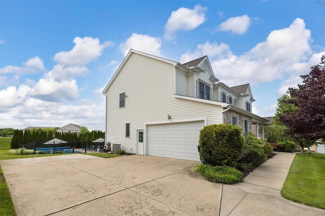6018 Pebble Creek Dr, Fairview, PA 16415 - view of side of home with concrete driveway and an attached garage