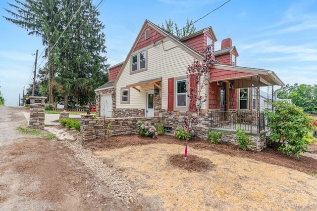 20527 Baird Rd, Meadville, PA 16335 - view of front of property with covered porch, stone siding, a chimney, and a garage