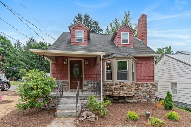 20527 Baird Rd, Meadville, PA 16335 - new england style home with roof with shingles, a chimney, stone siding, and covered porch