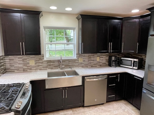 1742 W Gore Rd, Millcreek, PA 16509 - kitchen with appliances with stainless steel finishes, dark cabinets, backsplash, and recessed lighting