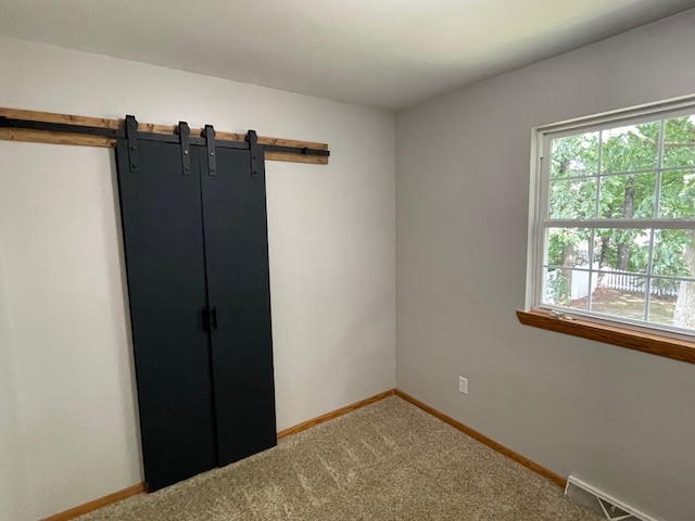 1742 W Gore Rd, Millcreek, PA 16509 - unfurnished bedroom featuring a barn door and carpet floors