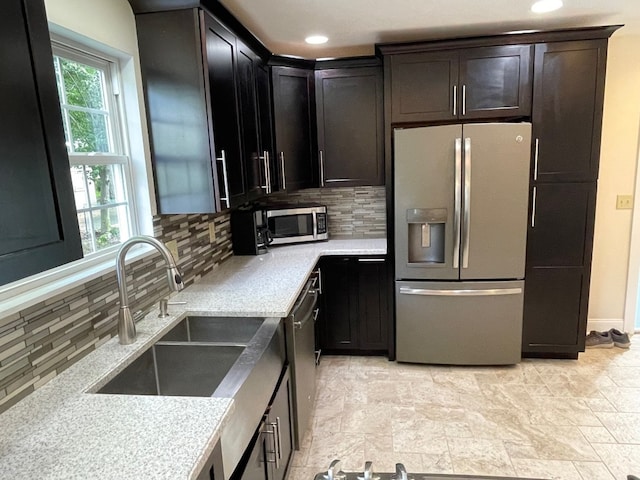 1742 W Gore Rd, Millcreek, PA 16509 - kitchen with appliances with stainless steel finishes, decorative backsplash, stone finish floors, and recessed lighting