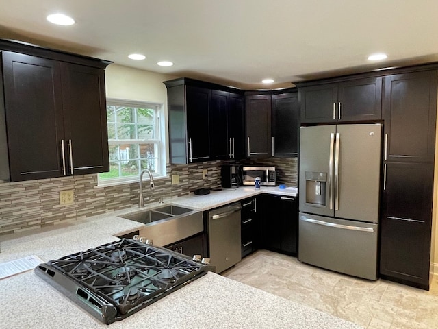 1742 W Gore Rd, Millcreek, PA 16509 - kitchen with stainless steel appliances, light countertops, decorative backsplash, recessed lighting, and dark cabinetry