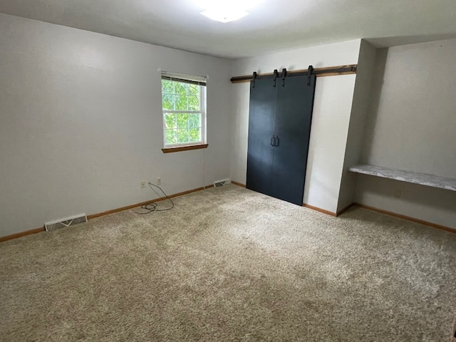 1742 W Gore Rd, Millcreek, PA 16509 - unfurnished bedroom featuring carpet floors and a barn door