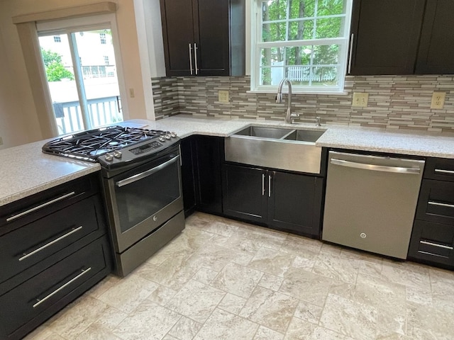 1742 W Gore Rd, Millcreek, PA 16509 - kitchen featuring stainless steel appliances, tasteful backsplash, and dark cabinetry