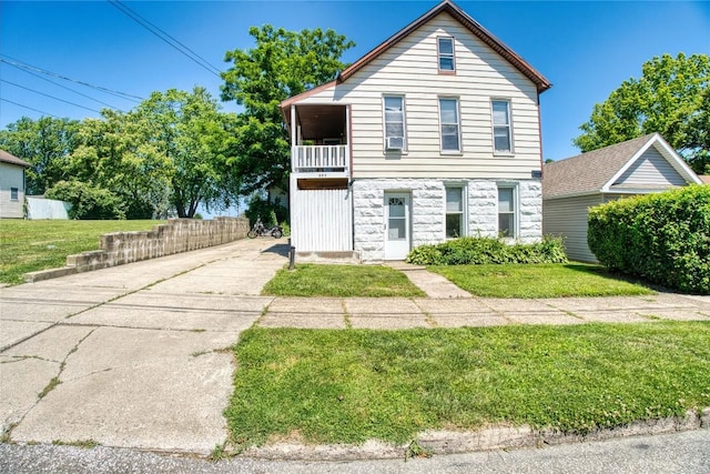 352 E 2nd St, Erie, PA 16507 - traditional home with stone siding, a balcony, a front lawn, and driveway