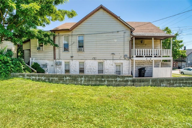 352 E 2nd St, Erie, PA 16507 - rear view of property with a lawn, stone siding, and a balcony