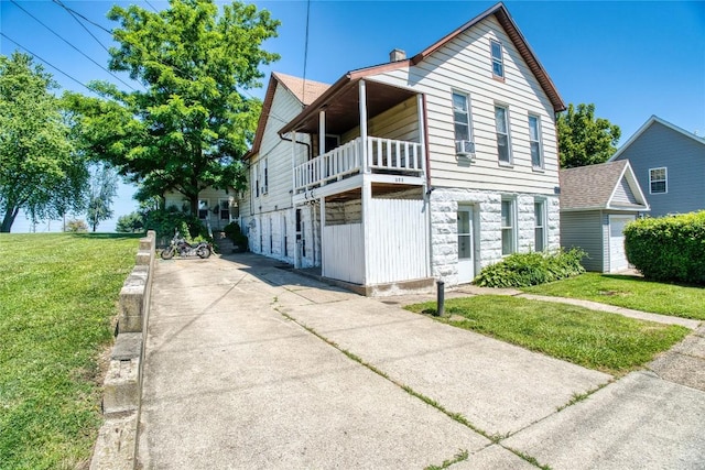 352 E 2nd St, Erie, PA 16507 - view of front of home featuring stone siding, a balcony, and a front yard