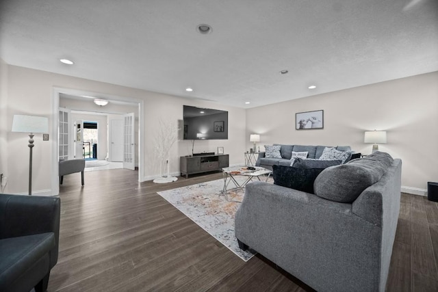 living room with french doors and dark wood-type flooring